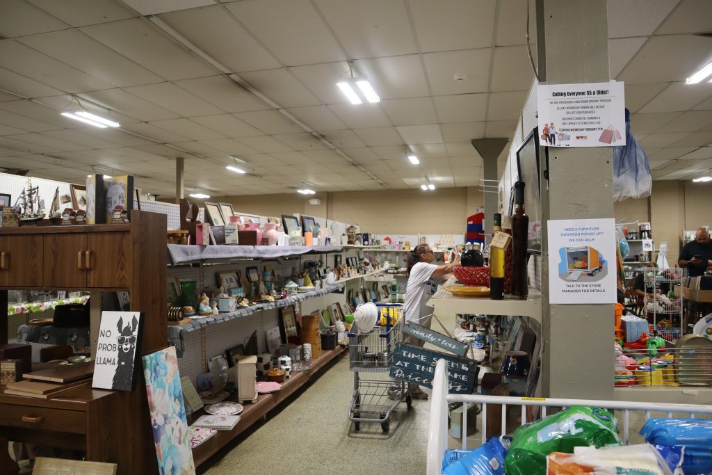 Stocked shelving at a thrift store.