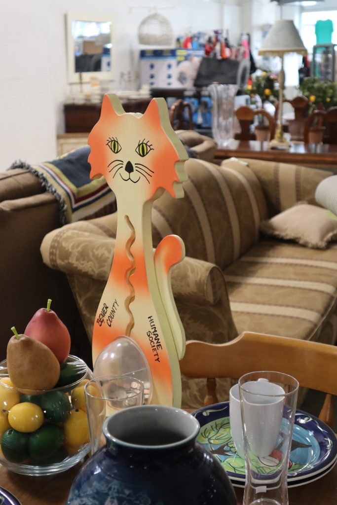 Dishware and sofas at a thrift store.